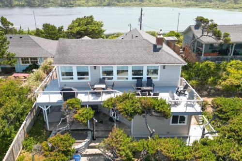 an aerial view of a white house with trees at Loki's Kingdom in Rockaway Beach