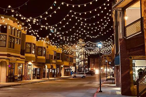 a street with lights hanging over a city at night at Northstar Nook in Edwards
