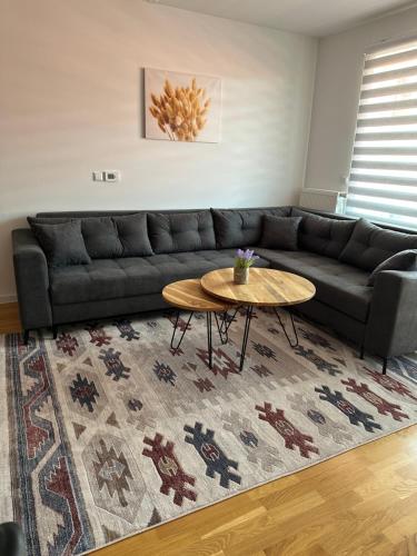 a living room with a couch and a coffee table at ZORA apartmani Sarajevo in Sarajevo