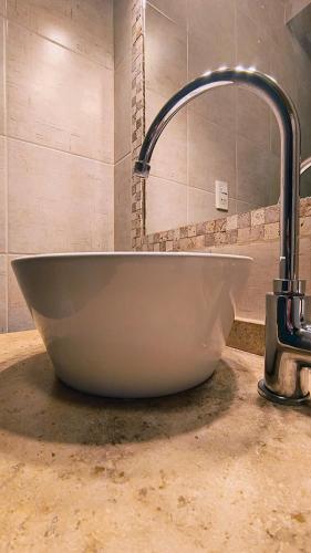 a bath tub sitting on a counter in a bathroom at Puerta Sur Apart in Malargüe