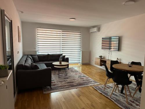 a living room with a couch and a table at ZORA apartmani Sarajevo in Sarajevo