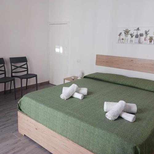 a bedroom with a large bed with four pillows on it at Casa vacanze terrAmare in Avola