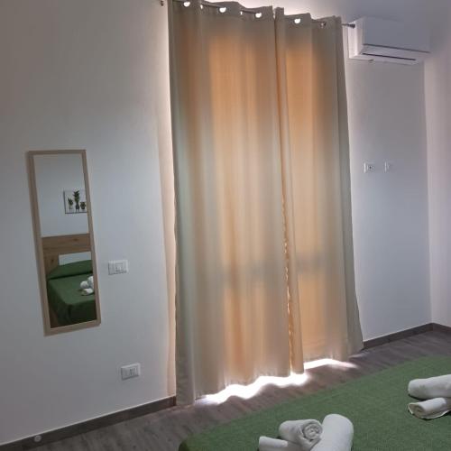 a room with a shower curtain and a mirror at Casa vacanze terrAmare in Avola
