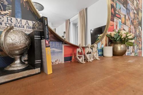 a shelf with a mirror and books and a trophy at Btqcentralacfreeparkingterrace in Zürich