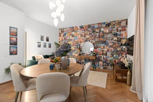 a dining room with a table and a wall of photos at Btqcentralacfreeparkingterrace in Zürich