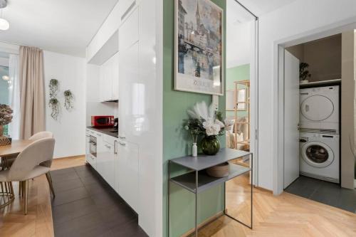 a kitchen and dining room with a washer and dryer at Btqcentralacfreeparkingterrace in Zürich