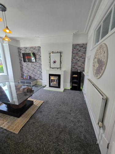 a living room with a fireplace and a tv at Charming & Energetic - 8ight Havens Folkestone in Folkestone