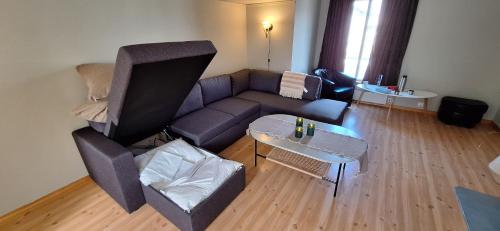 a living room with a couch and a table at Storgata 78, Leknes sentrum in Leknes