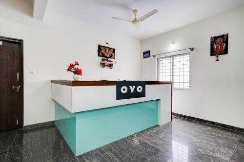 an office with a reception desk in a room at Hotel O Sri Krishna Comforts in Bengaluru
