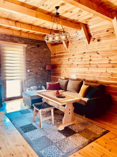 a living room with a couch and a table at Guest House LENA in Žabljak