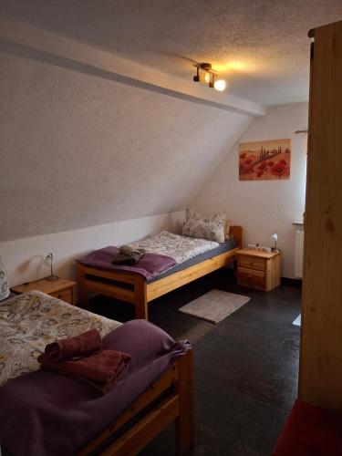 a room with two beds and two tables in it at Ferienwohnung am Sachsenring in Bernsdorf