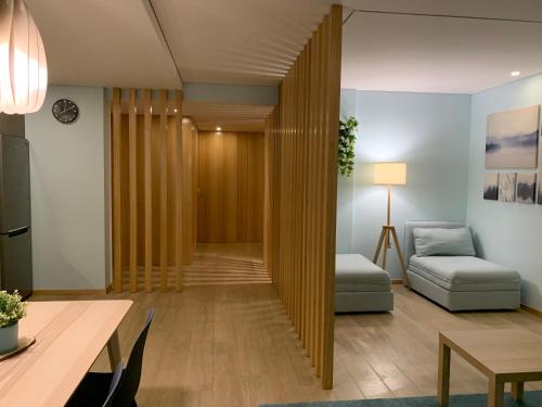 a living room with a couch and a table at Casa do Recife, Natureza e Conforto in Viana do Castelo