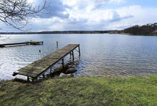 a wooden dock in the middle of a lake at Ferienwohnung Renate in der Villa Seeblick in Bad Saarow