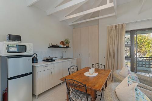a kitchen and a living room with a table and a kitchen at Cape Goodness in Bellville