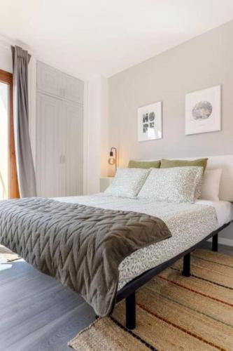 a bedroom with a bed in a white room at Charming place near the beach Casa Checha in Candelaria