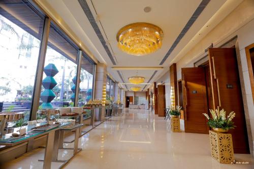 a hallway of a restaurant with tables and windows at Crowne Plaza Today Gurugram by IHG in Gurgaon