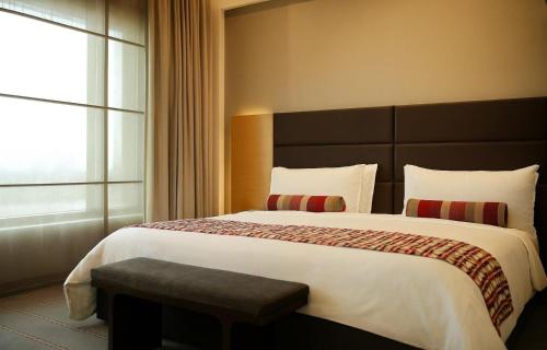a bedroom with a large bed and a window at Crowne Plaza Today Gurugram by IHG in Gurgaon