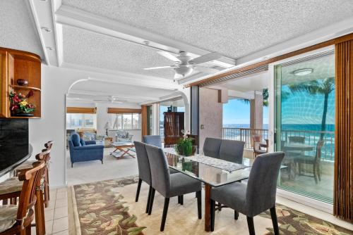 a dining room and living room with a table and chairs at Big Island Kona Reef D-22 by Coldwell Banker Island Vacations in Kailua-Kona