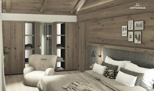 a bedroom with a bed and a chair at Miraval NaturHotel in Badia