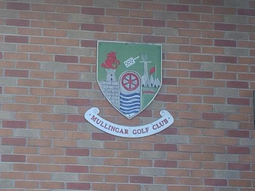 a shield on the side of a brick wall at Relaxing Balcony Views Mullingar Self Catering Apartment on Park Hotel Grounds in Mullingar