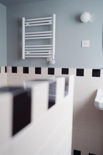 a bathroom with a air conditioner on the wall at LALA Hôtel in Paris