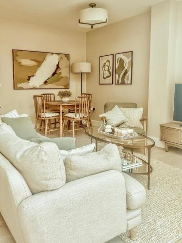 a living room with a white couch and a table at Stylish 3BD Townhouse in Central Winchester in Winchester