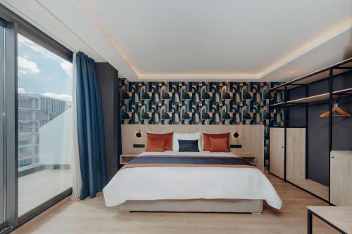 a bedroom with a large bed and a large window at Exe Casablanca in Casablanca