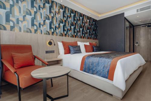 a bedroom with a bed and a chair at Exe Casablanca in Casablanca