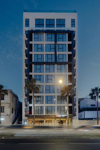 a tall white building with a street in front of it at Exe Casablanca in Casablanca
