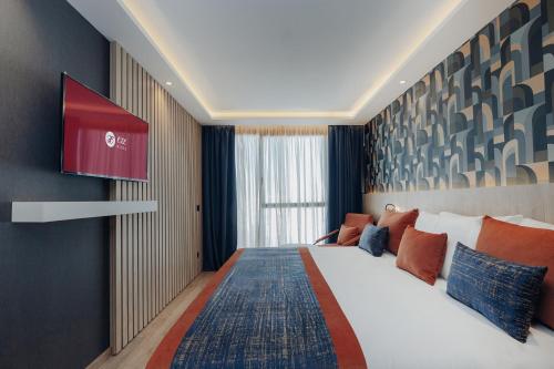 a hotel room with a large bed and a tv at Exe Casablanca in Casablanca