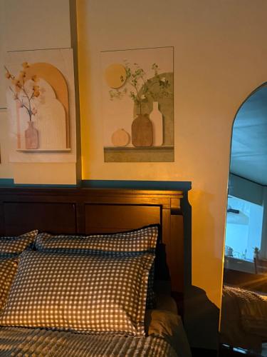 a bedroom with a bed and two vases on the wall at Casita del Mabini in Mabini