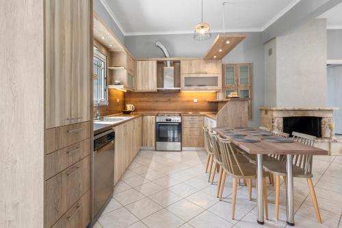 a kitchen with a wooden table and chairs and a stove at Martas Dream - Near Beach Apartments in Daratso