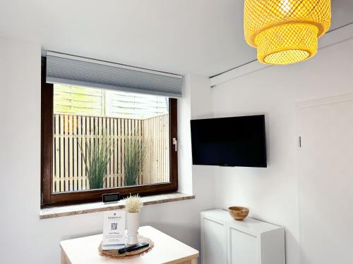a living room with a window and a television at Preiswertes Mini-Appartement ideal für eine Nacht in Scharbeutz