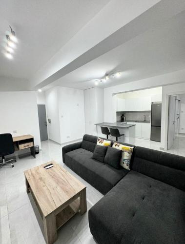 a living room with a couch and a table at Modern One-Bedroom Suite with Balcony in Central Nicosia in Nicosia