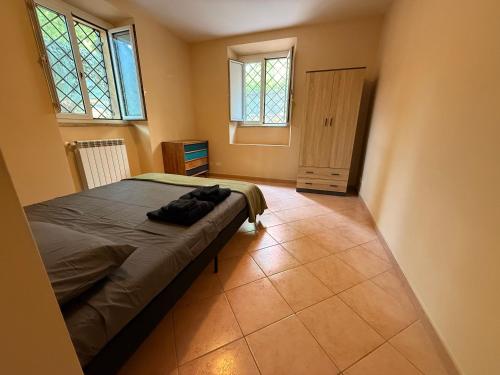 a bedroom with a bed and two windows at Casa Leone vicino al mare in Lido di Ostia