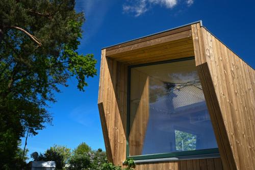 a wooden house with a window on top of it at Green Tiny Spot Salemer See - Tiny House Nook 5 in Salem