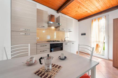 a kitchen with a table with a blender on it at Ittiturismo Isola Rossa L'agrumeto in Teulada