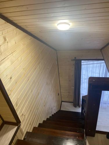 an attic room with stairs and a window at Шпінь 4 in Vorokhta