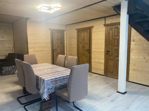 a dining room with a table and chairs at Шпінь 4 in Vorokhta