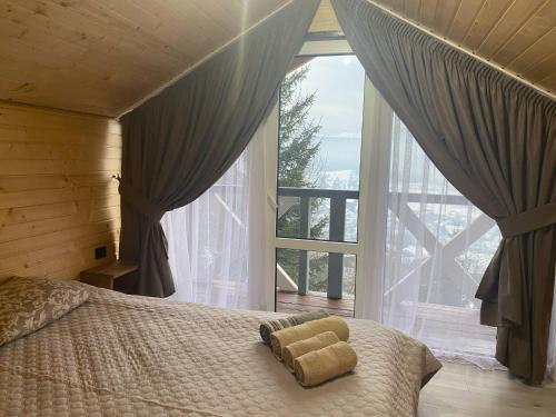 a bedroom with a bed in front of a large window at Шпінь 4 in Vorokhta