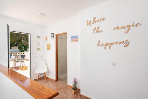 a hallway with a white wall with the words when the magic happens at Sunset Village in Can Picafort