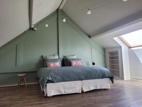 a bedroom with a large bed in a room with a window at L'Annexe de Steph in Loulans-Verchamp