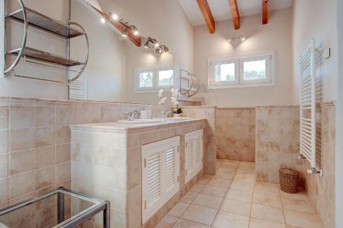 a bathroom with a sink and a mirror at Ca na Margalida in Manacor