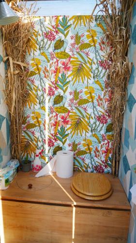 a table with a wall with a tropical wallpaper at La Forge - calme absolu avec vue sur les Pyrenées in Villarzel-du-Razès
