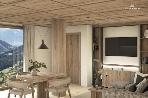 a living room with a table and a tv at Miraval NaturHotel in Badia