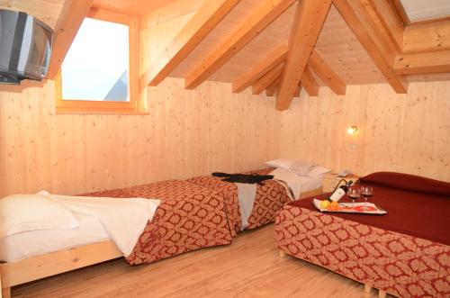 Postel nebo postele na pokoji v ubytování Hotel Corona
