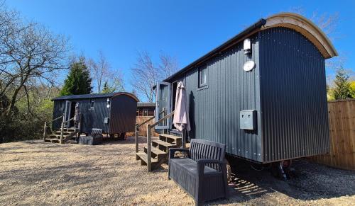 a couple of tiny homes parked in a yard at Loch Lomond Waterfront Luxury Lodges in Balmaha