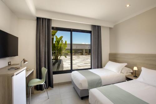 Postel nebo postele na pokoji v ubytování Simon Hotel Aprilia