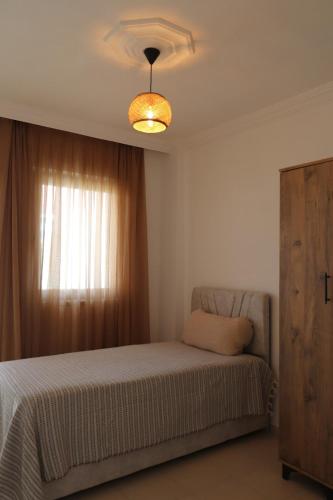 a bedroom with a bed and a window at Blackwood Flava Cora in Datca