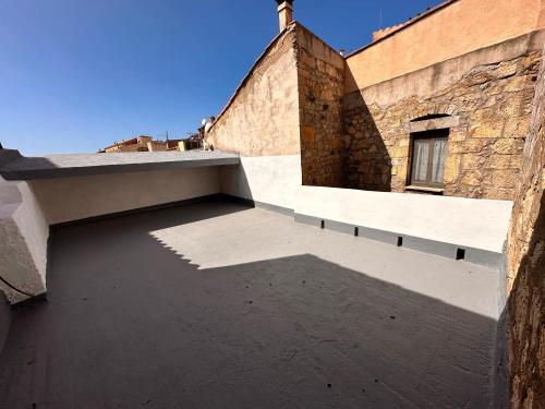 a building with a shadow on the side of it at Domo Mea - La Tua Casa In Sardegna in Cuglieri